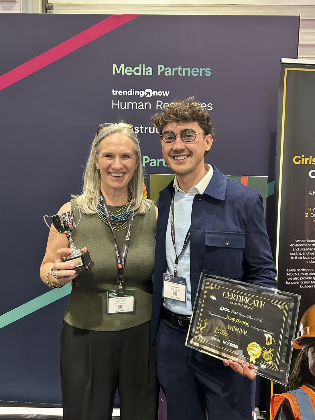 Lindsay Mattinson and Lewis Wood holding the Pitch Your Plan 2026 trophy and winner's certificate